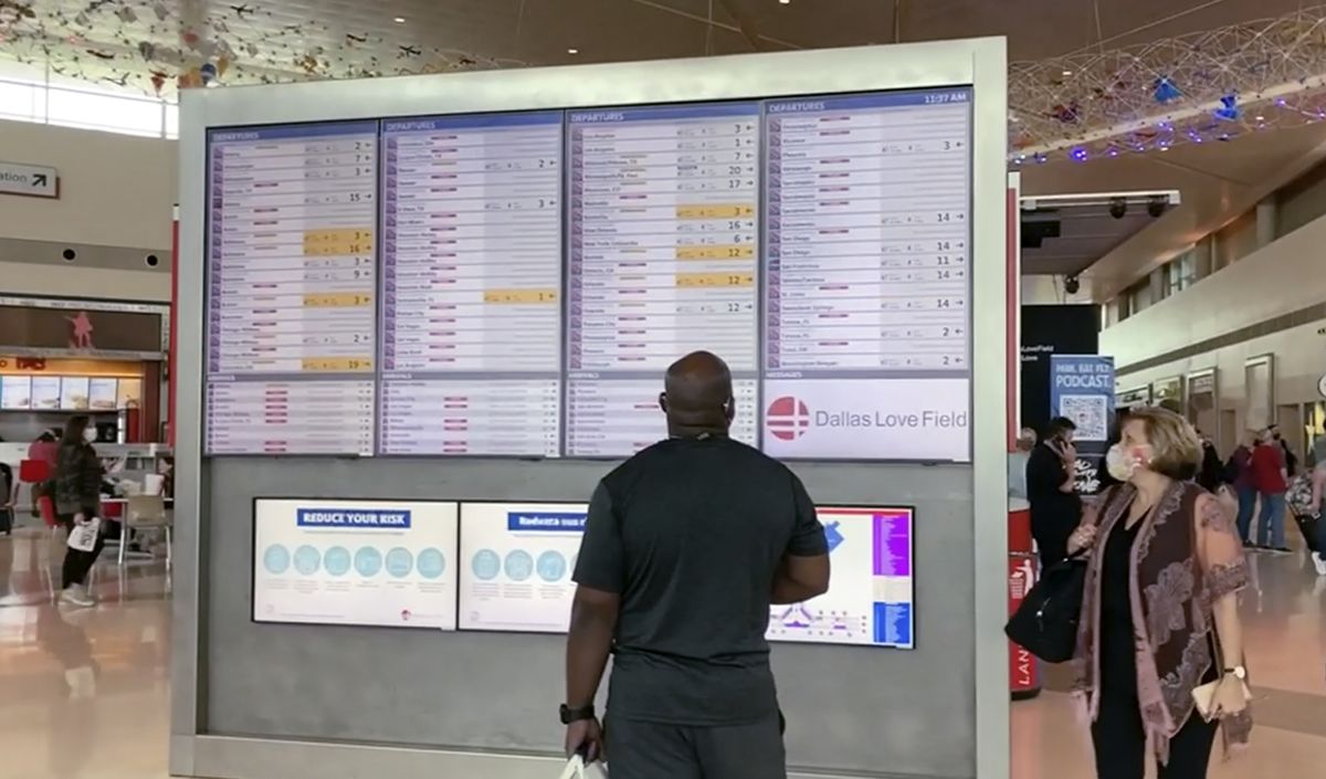 In this frame grab from cellphone video, passengers look for information on their flights, Sunday, Oct. 10, 2021, at Dallas Love Field. Southwest Airlines canceled hundreds of flights over the weekend, blaming the woes on air traffic control issues and weather.  (Julie March)