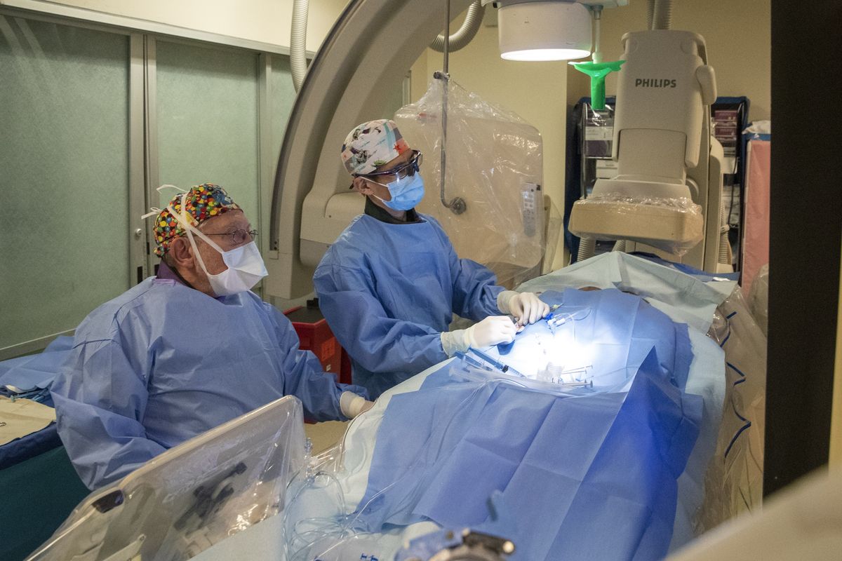 In this Feb. 26 photo, Director of Pediatric Cerebral Vascular Program Dr. Alejandro Berenstein performs an embolization on Omar Patzán with the assistance of attending interventional neuroradiologist Tomoyoshi Shigematsu at the Mount Sinai Hospital in New York.  (Mary Altaffer/Associated Press)