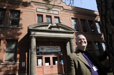 Brian Shute, a speech pathologist at Franklin Elementary, stands in front of the school Friday. The school is 100 this year.  (Jesse Tinsley / The Spokesman-Review)