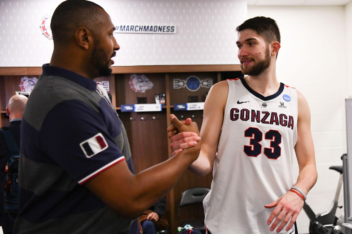 Gonzaga Bulldogs forward Killian Tillie (33) shakes hands with Boris Diaw after the second half of a second round mens basketball game in the NCAA Tournament  on Saturday, March 23, 2019, at Vivint Smart Home Arena in Salt Lake City, Utah. Gonzaga won the game 83-71. (Tyler Tjomsland / The Spokesman-Review)