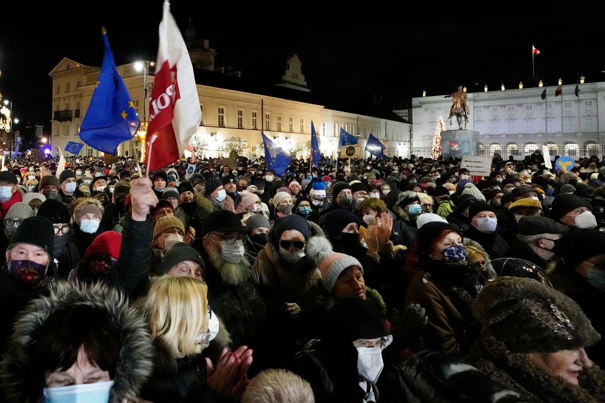 People demonstrate after the Polish parliament approved a bill that is widely viewed as an attack on media freedom, in Warsaw, Poland, Sunday Dec. 19, 2021. Poles flocked to city centers across the country to defend a U.S.-owned television network that is being targeted by the right-wing government. The protests Sunday evening are seeking to protect media freedom in a European Union nation where democratic norms are eroding.  (Czarek Sokolowski)
