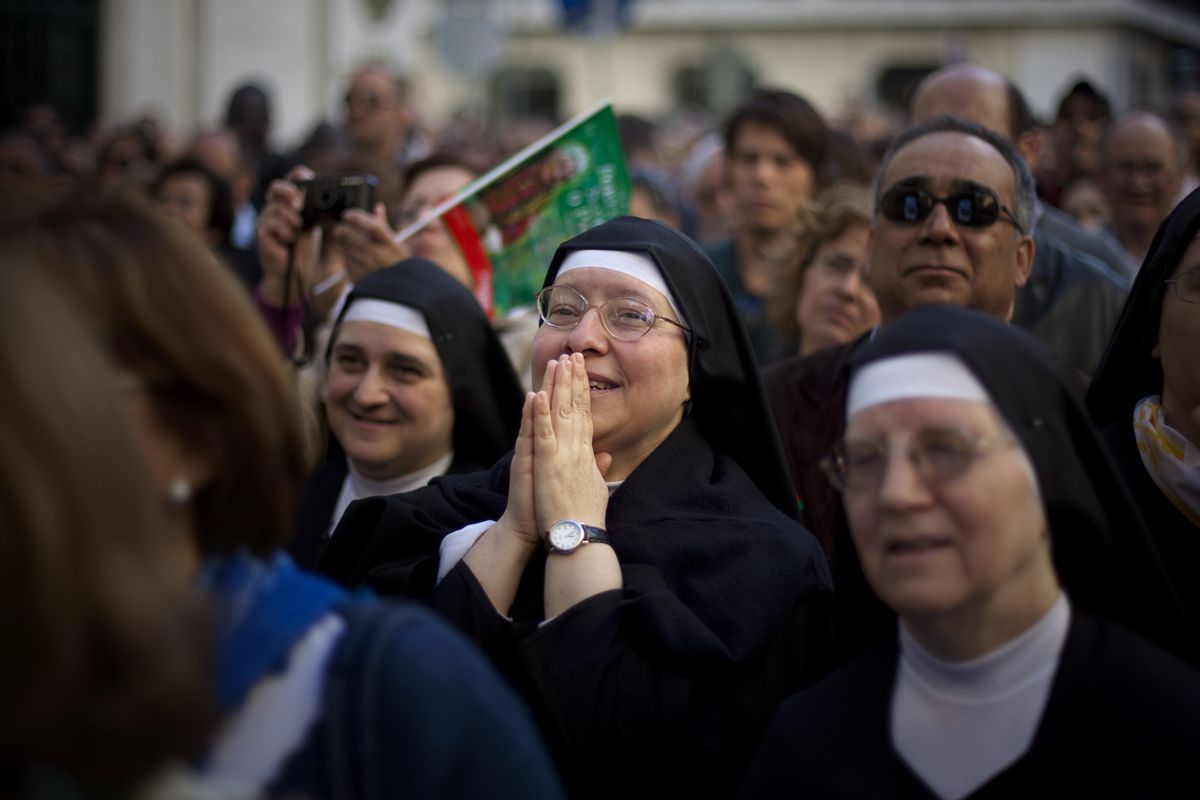 Nuns watch on a screen as the pope conducts Mass at the Terreiro do Paco square in Lisbon Tuesday. Associated Press photos (Associated Press photos)