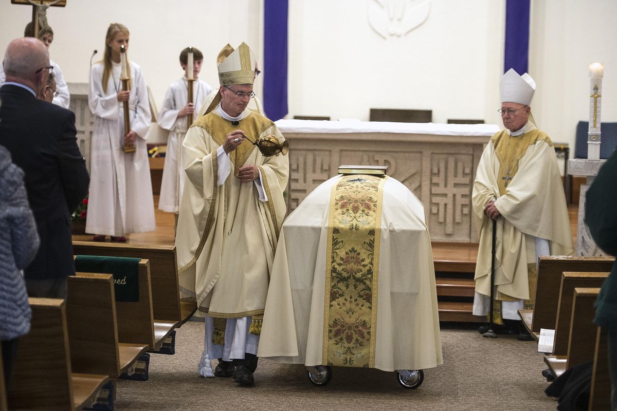 Spokane Bishop Thomas A. Daly performs the final commendation during the funeral mass for  Father Frank J. Bach on Thursday, Dec 21, 2017, at St. Mary Catholic Church. (Colin Mulvany / The Spokesman-Review)