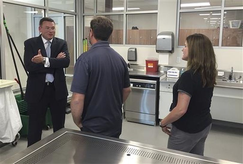 In this June 20, 2016 photo, Dr. Robert Hasty, the dean of the for-profit Idaho College of Osteopathic Medicine, talks with Idaho State University Meridian Health Science Center employees Chris Wilson, center, and Nancy Carpenter in Meridian, Idaho. ICOM and ISU have reached an agreement that will allow the for-profit school's students to use the public university's facilities when ICOM opens in 2018. (AP / Rebecca Boone)