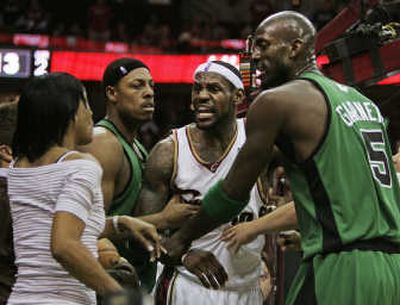 
Cleveland's LeBron James, second from right, yells at his mother, Gloria, who left her seat after a hard foul on James. Associated Press
 (Associated Press / The Spokesman-Review)