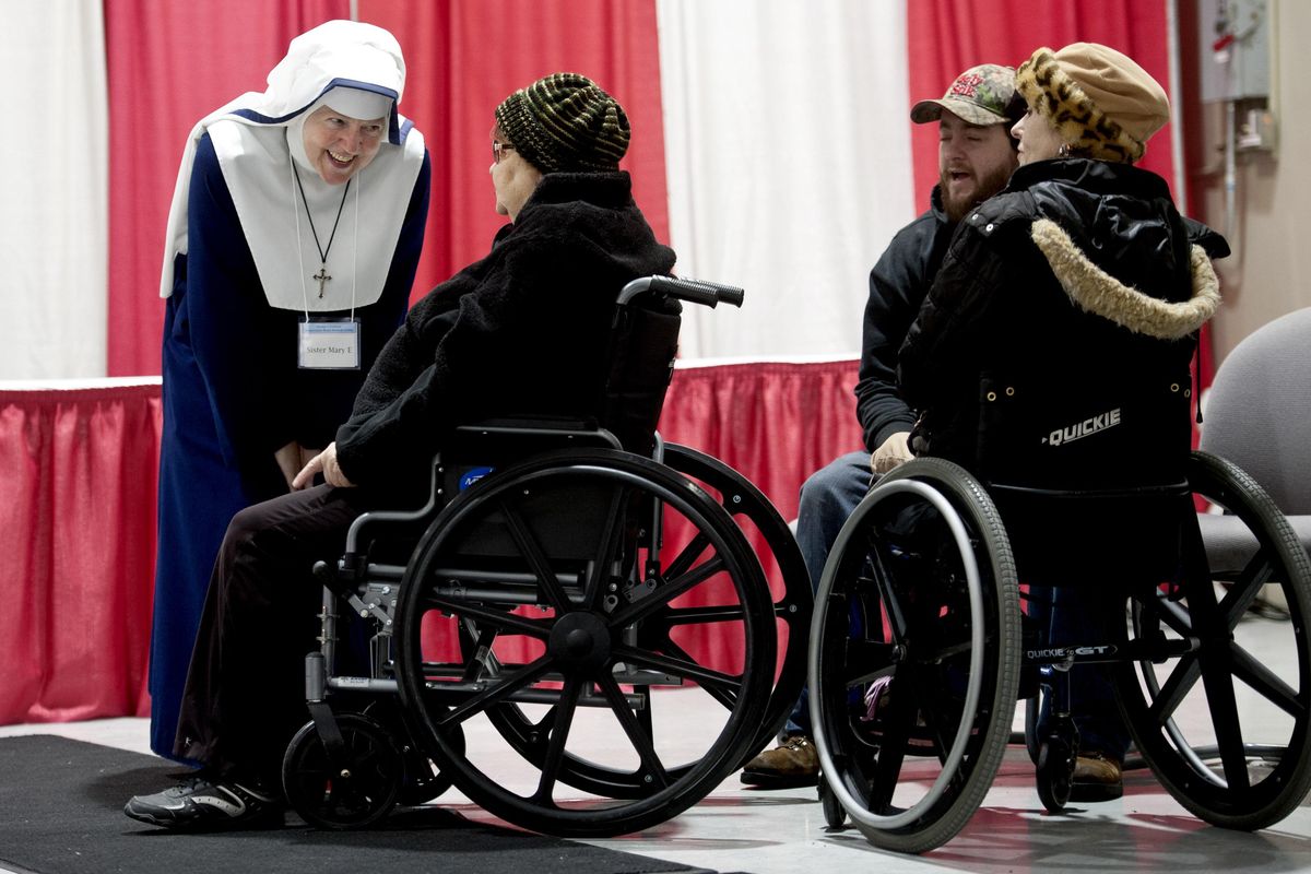 "It feeds our souls," said Sister Mary Ercharitsa S.M.M.C (Sisters of Mary, Mother of the Church) as she greets people at the Christmas Bureau on Monday, Dec. 18, 2017. (Kathy Plonka / The Spokesman-Review)
