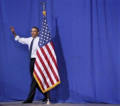 President Barack Obama walks out to speak at Washington-Lee High School in Arlington, Va., on Friday. (Associated Press)