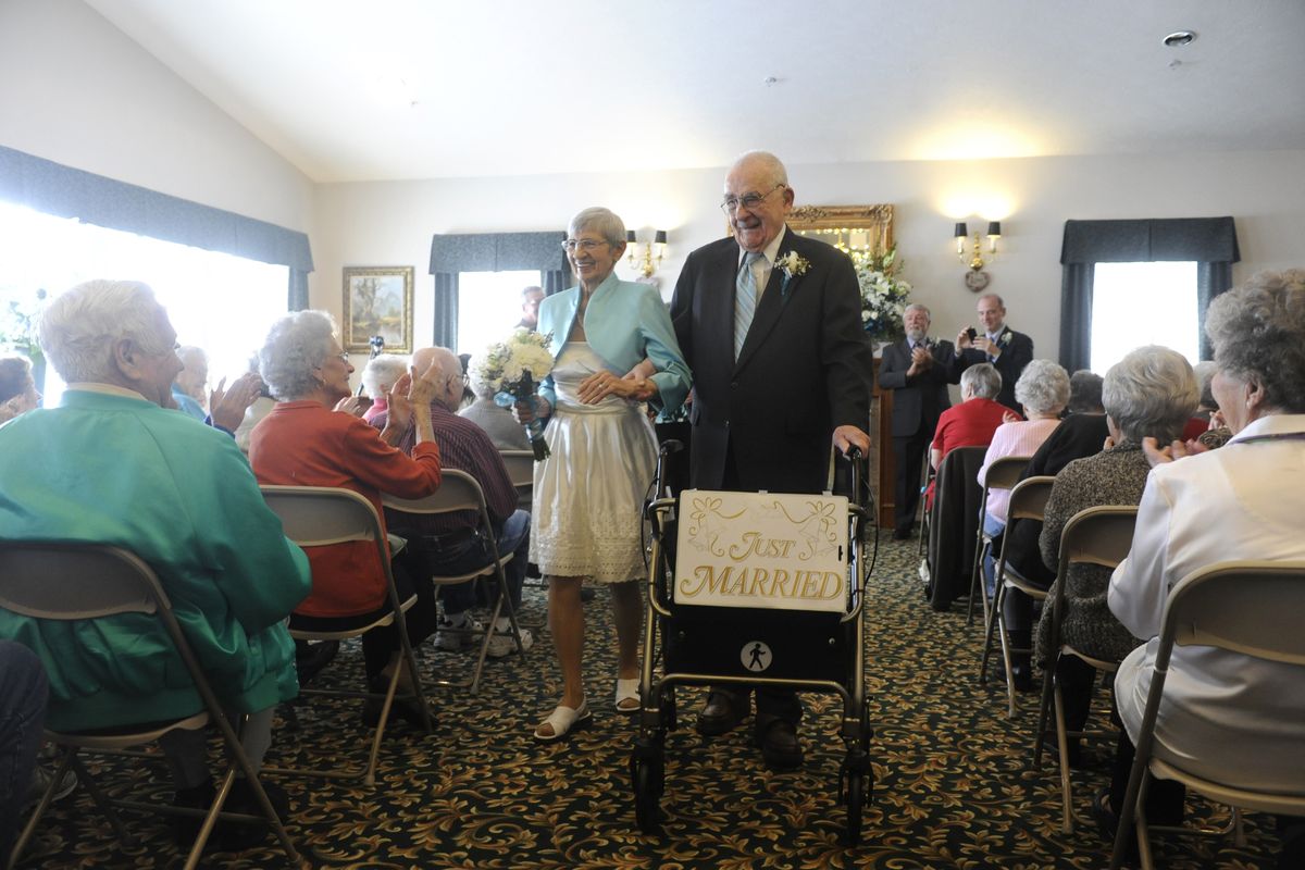 Lorraine Lanterman and Kent Collings walk down the aisle after saying their marital vows Saturday at Orchard Crest Retirement Community in Spokane Valley. She is 77, and he is 95. (PHOTOS BY JESSE TINSLEY)