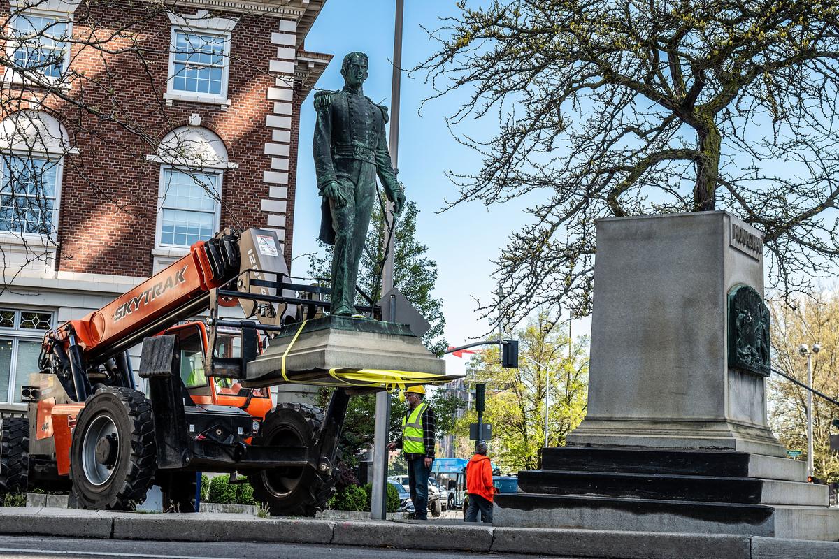 After standing in downtown Spokane for 120 years, the statue of Ensign John Monaghan was removed on April 29. The city paid $88,000 to Spokane Valley moving company Breithaupt & Sons to transfer the statue closer to the Monaghan family mausoleum in Fairmount Memorial Park.  (Colin Mulvany/THE SPOKESMAN-REVIEW)