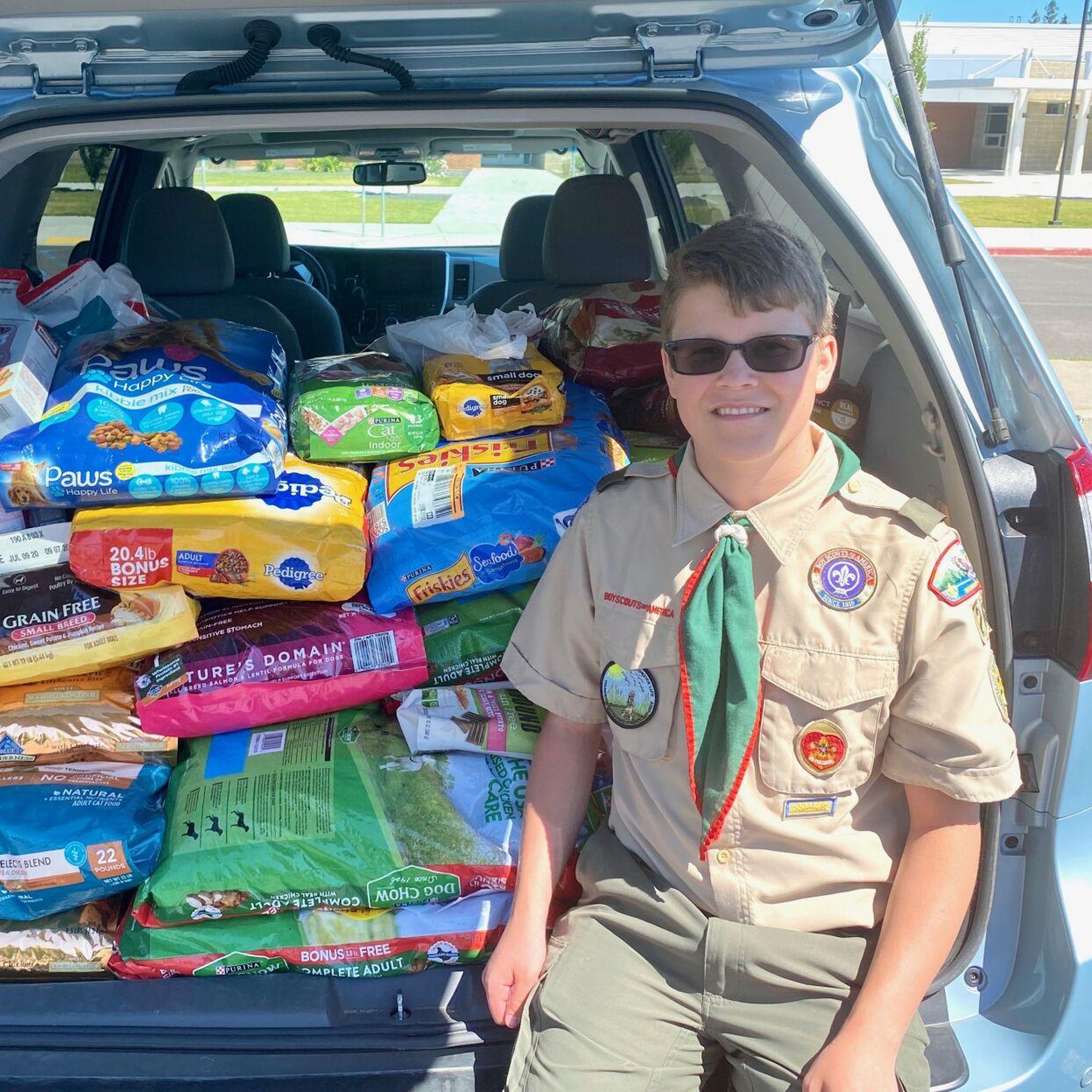 New scouts receive uniforms, donate food