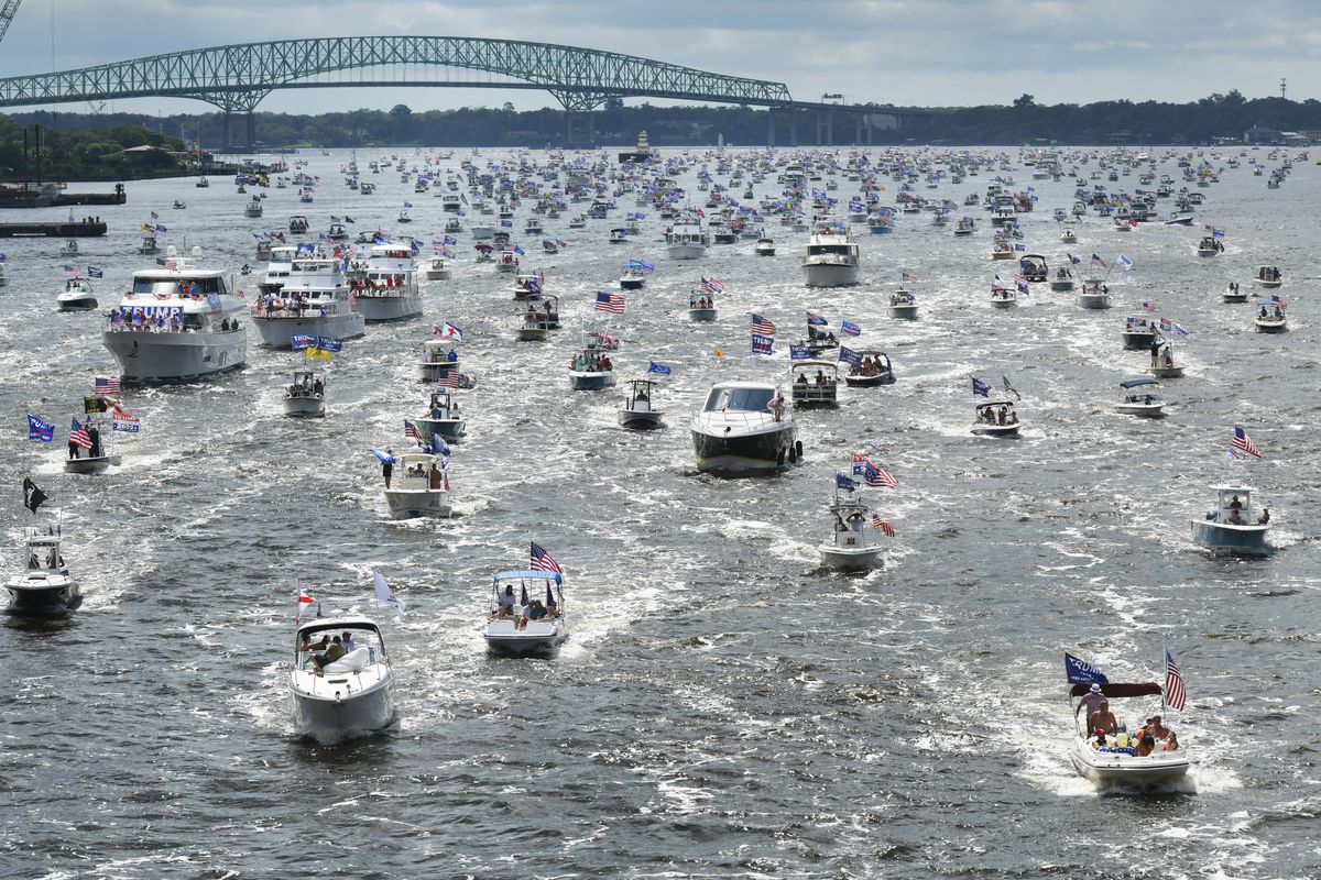 Hundreds of boats idle through downtown on the St. Johns River during a rally Sunday, June 14, 2020, in Jacksonville, Fla., celebrating President Donald Trump