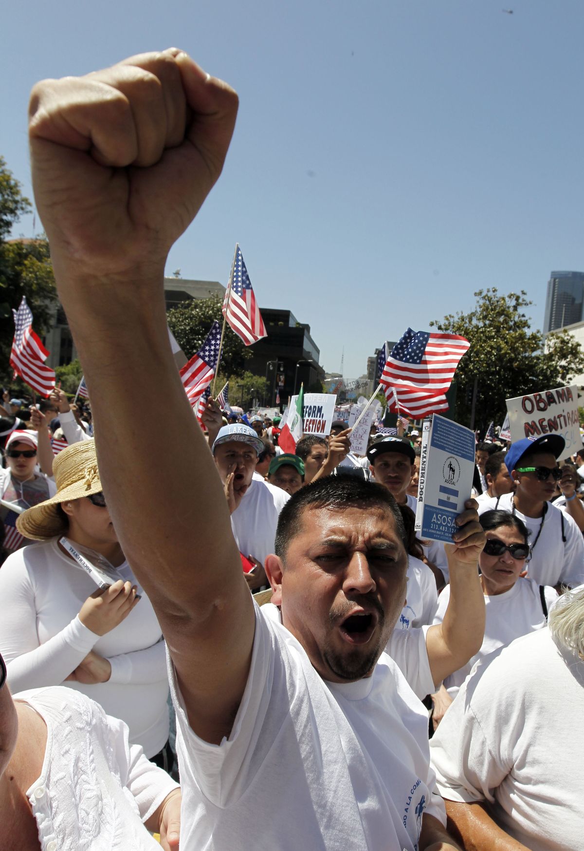 A man raises his fist at the rally  in downtown Los Angeles on Saturday.