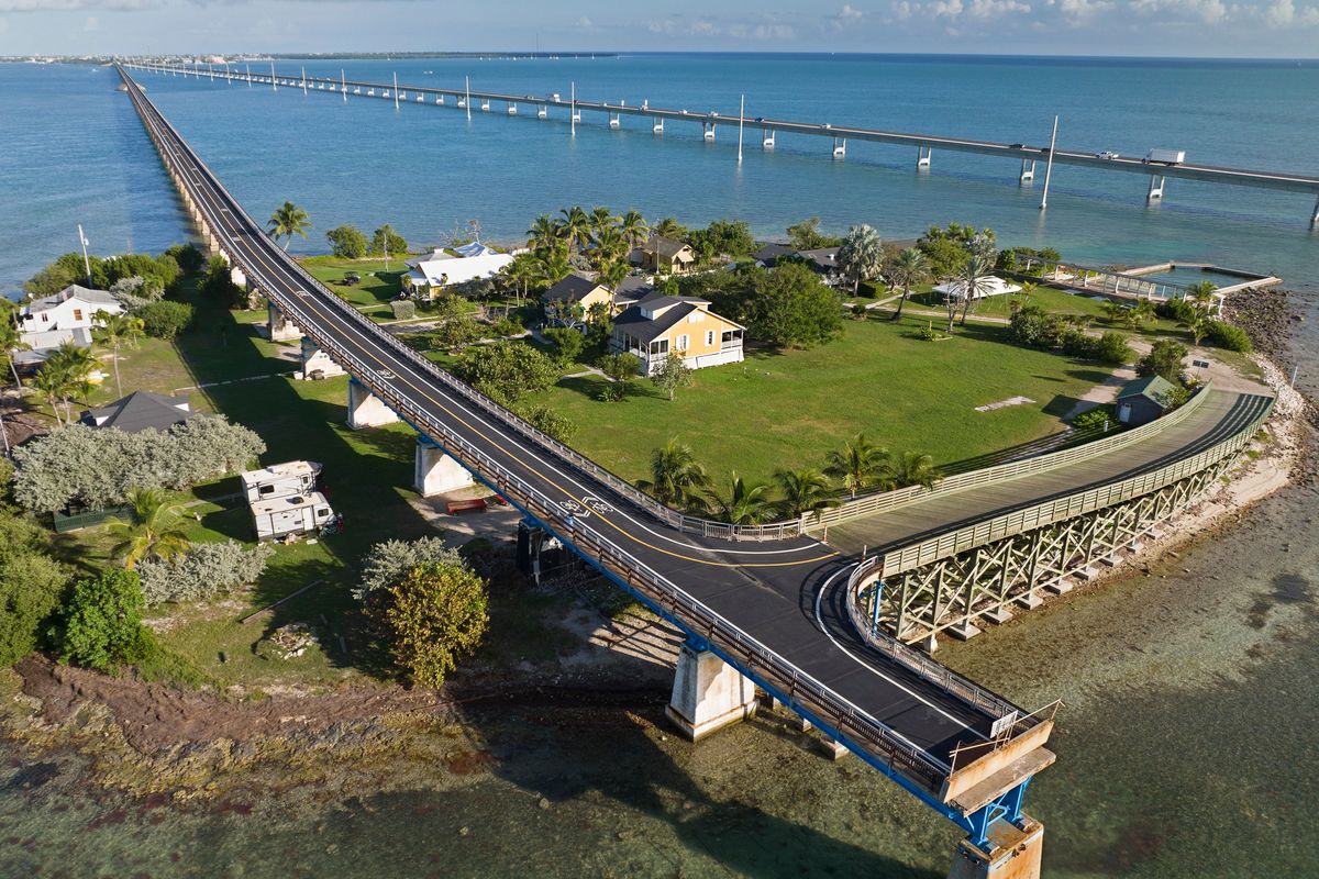 This Monday, Jan. 10, 2022, drone aerial photo provided by the Florida Keys News Bureau shows the Old Seven Mile Bridge ready for its Wednesday, Jan. 12, 2022, reopening to pedestrians, bicyclists, anglers and visitors to Pigeon Key (island shown in photo). The old bridge originally was part of Henry Flagler