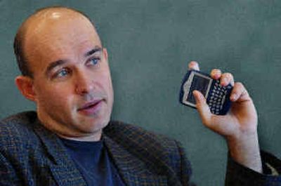 
Research In Motion Ltd. chairman and co-CEO Jim Balsillie holds a Blackberry.  
 (Associated Press / The Spokesman-Review)