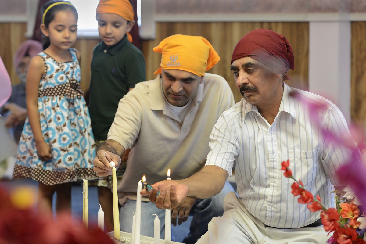 Sikh congregants light candles during a remembrance ceremony at the Sikh Temple of Spokane on Wednesday. (Dan Pelle)