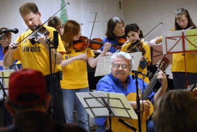 
Darin Weiler, left, and Jim Foss on guitar, play a duet accompanied by the rest of the West Valley Kiwanis Family Fiddlers during a performance at Park Place Retirement Community. All 90 violins in the free fiddle program are currently checked out. 
 (Photos by HOLLY PICKETT / The Spokesman-Review)