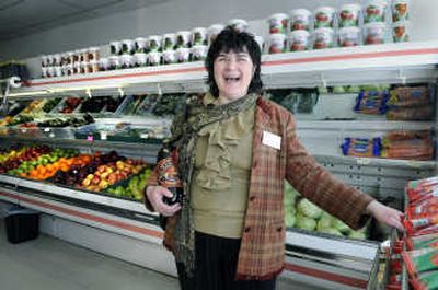 
Tatyana Bistrevsky laughs while handling tubes of garlic ketchup at a Slavic  market in Spokane. 
 (Dan Pelle / The Spokesman-Review)