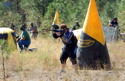 Members of the attackers group advance on the defenders’ positions through a speed ball field, an open area dotted with inflatable obstacles, as they force the defenders to fall back to the tower they were defending during a recent game of Mortar Wars at Nitehawk Paintball near Ford, Wash.  (Photos by Jesse Tinsley / The Spokesman-Review)