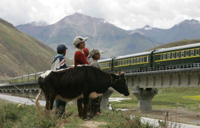 
Tibetan children watch as the first train from Lhasa Railway Station travels on the Tibetan grasslands near Lhasa, Tibet.
 (Associated Press photos / The Spokesman-Review)
