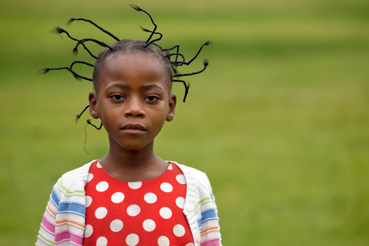 Divine Kabura, 7, of The Republic of Congo poses for a photograph during World Refugee Day at Nevada Park in Spokane on Saturday, June 16, 2018. (Kathy Plonka / The Spokesman-Review)