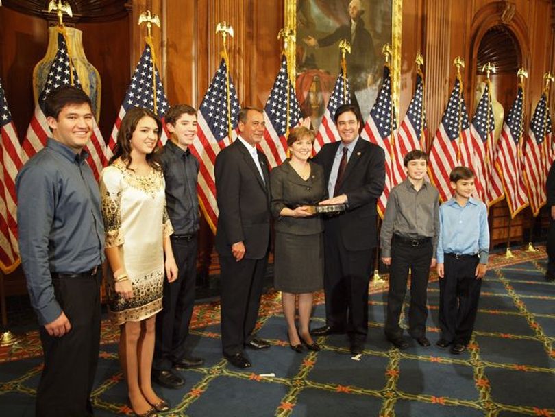 Idaho Congressman Raul Labrador and his family pose with House Speaker John Boehner in a ceremonial swearing-in photo on the first day of the new Congress, 1/5/11