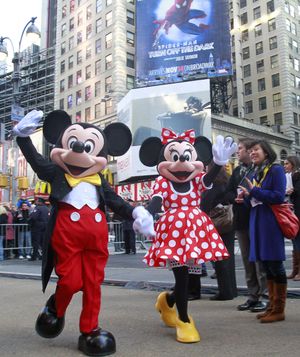 Disney characters Mickey Mouse and Minnie Mouse arrive at the grand opening celebration of the premier Disney Store on Tuesday at Times Square in New York. The crown jewel among approximately 360 stores worldwide, the newest emporium is expected to generate 5 percent of the chain’s North America revenue with an estimated 1.5 million passers-by daily.  (Associated Press)
