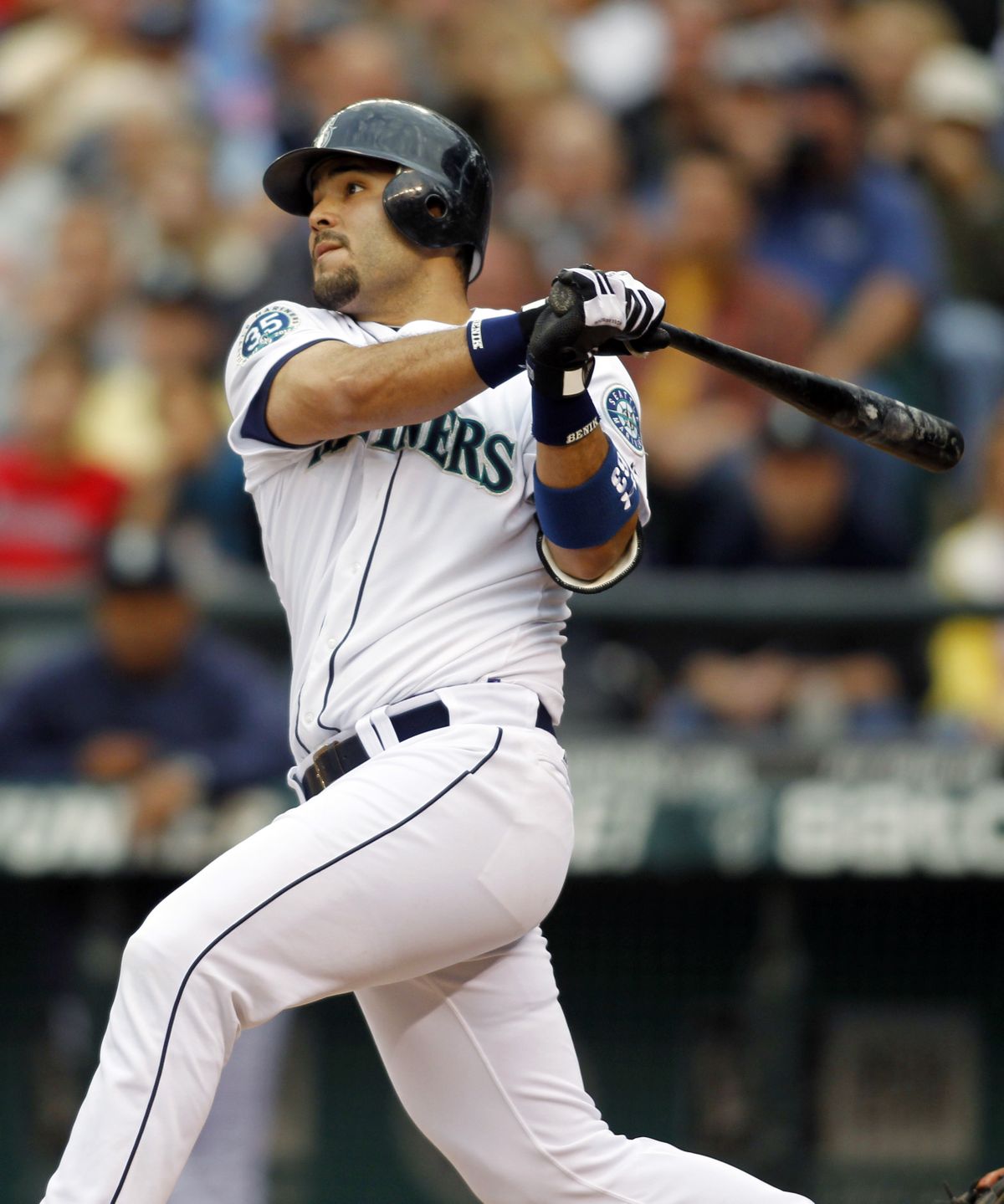 Seattle’s Jesus Montero hits a solo homer during the first inning Saturday night at Safeco Field. (Associated Press)