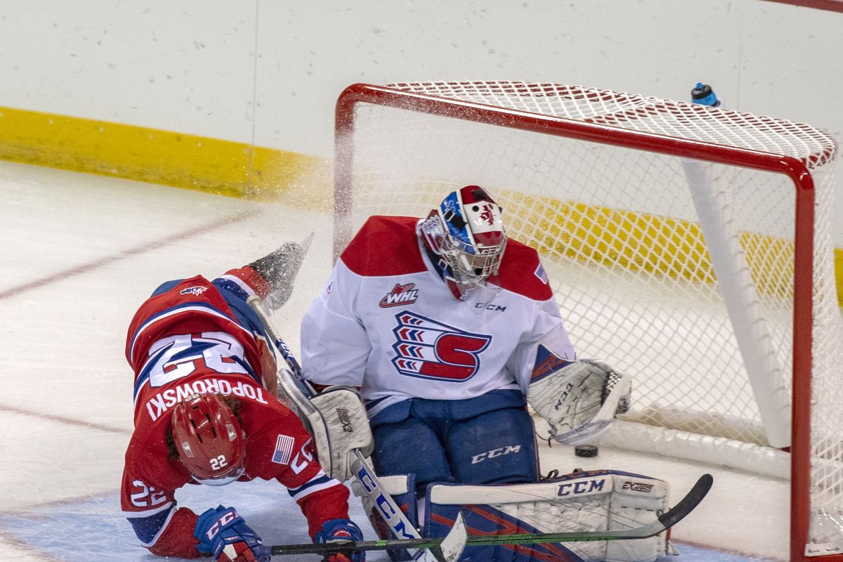 Forward Luke Toporowski flies into goalie Campbell Arnold as he follows his puck into the goal after scoring in the Spokane Chiefs’ annual Red-White Game on Sept. 5 at the Spokane Arena.  (Jesse Tinsley/THE SPOKESMAN-REVI)