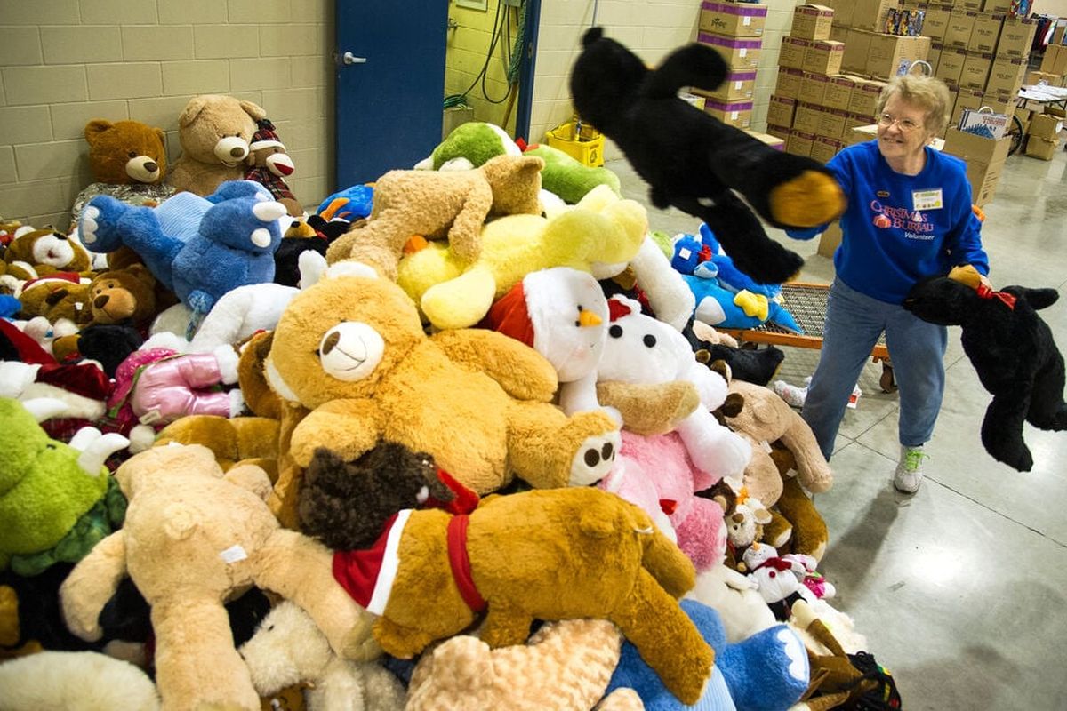 Fern Swecker, who a had been a Christmas Bureau volunteer for 27 years, helps sort 6,000 stuffed animals donated from fans at the Teddy Bear Toss Night in this file photo.  (COLIN MULVANY/THE SPOKESMAN-REVIEW)