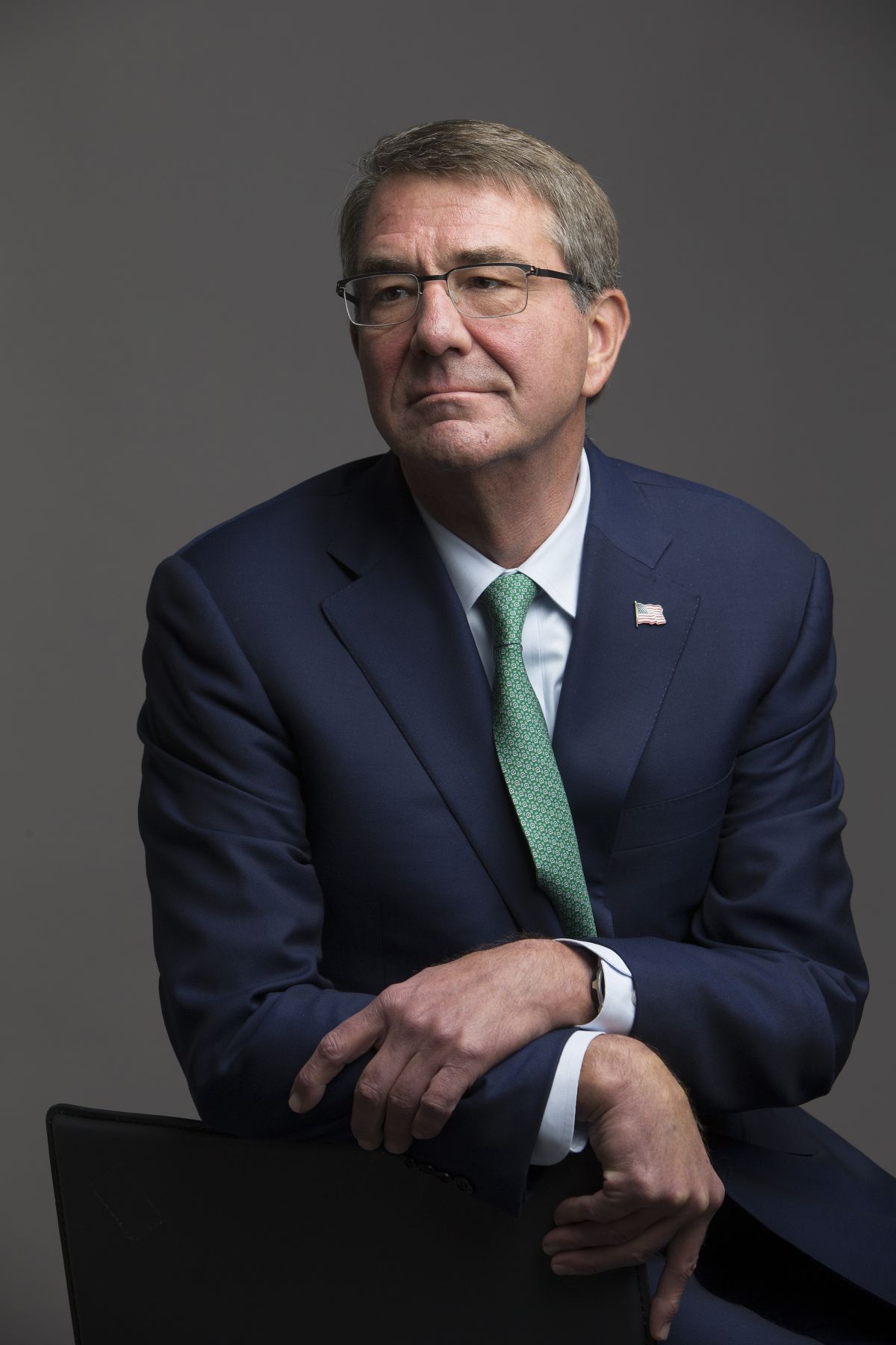 Secretary of Defense Ash Carter steadies his hand using the