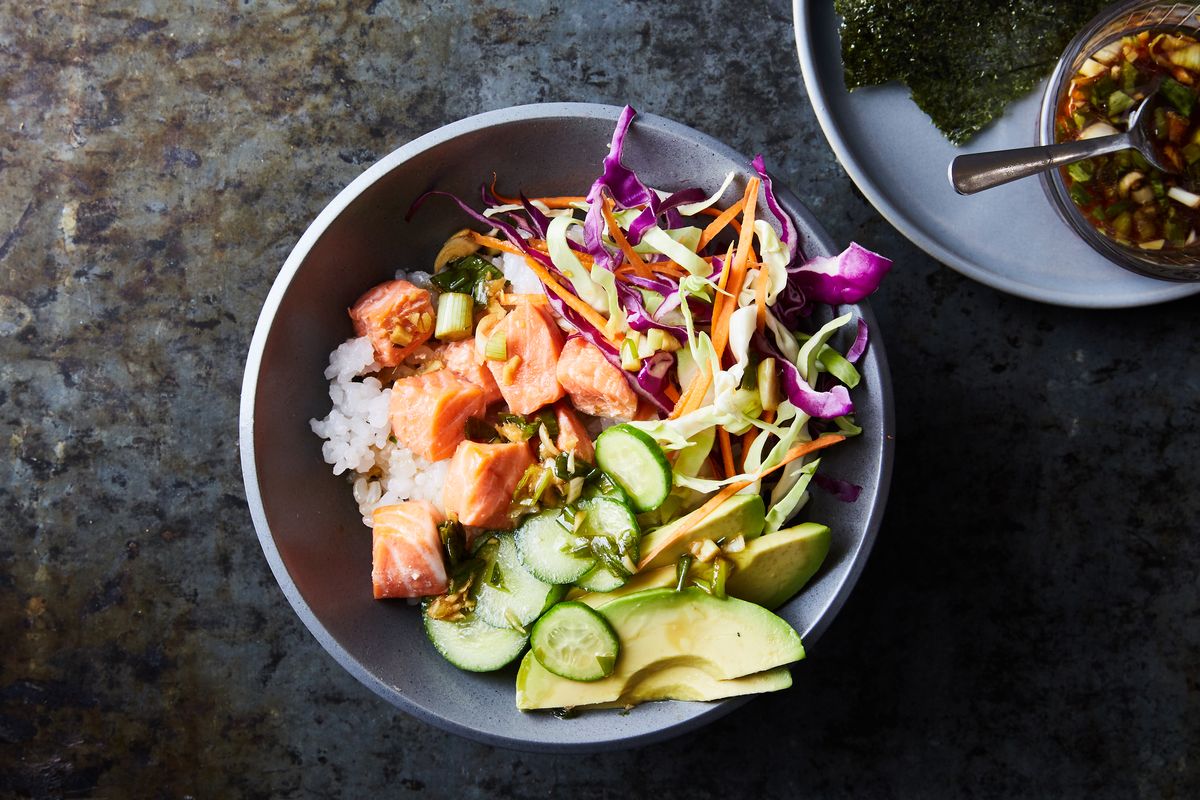 Kay Chun’s sesame salmon bowls where everyone can get the whole beautiful bowl, or a version customized to their specs. For little kids, make the salmon and rice as directed, then plate those plain, not touching each other, with whatever fixings they may eat.   (LINDA XIAO/New York Times)