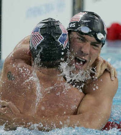 
Michael Phelps, right, of the U.S. and teammate Erik Vendt embrace after finishing first and second, respectively.
 (Associated Press / The Spokesman-Review)