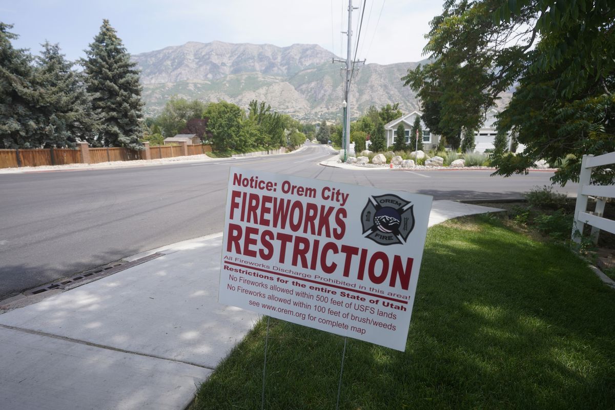 A "Orem City Fireworks Restriction" sign is shown on Tuesday, June 22, 2021, in Orem, Utah. Many Americans aching for normalcy as pandemic restrictions end are looking forward to traditional Fourth of July fireworks. But with a historic drought in the U.S. West and fears of another devastating wildfire season, officials are canceling displays, passing bans or begging for caution. (Rick Bowmer)