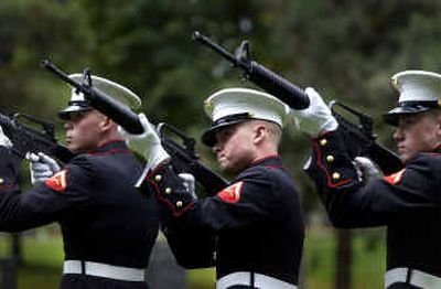 
A Marine honor guard, from left, Lance Cpl. Ryan Galantuomini, Pfc. Ryan Dowell and Lance Cpl. Noah Evermann, fires three volleys Saturday at the funeral of Ron Rankin.
 (Photos by Jesse Tinsley/ / The Spokesman-Review)