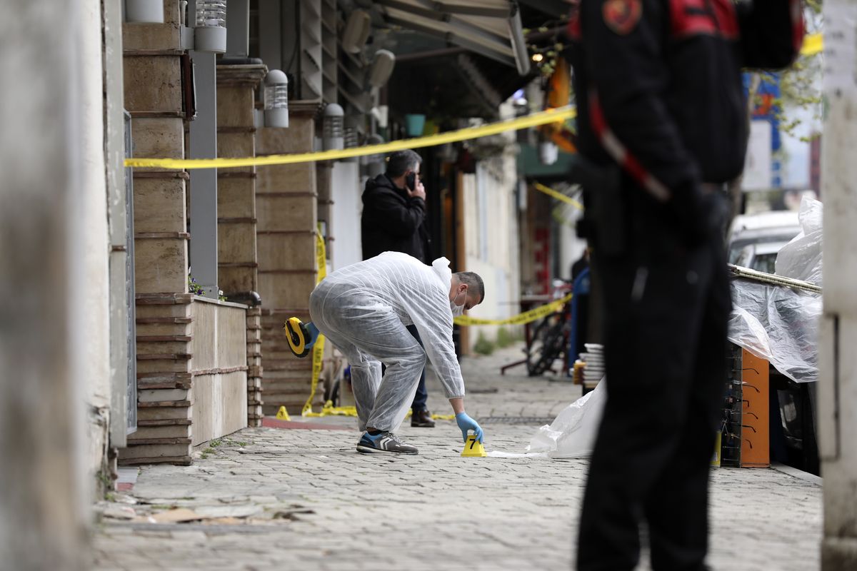 A policeman investigates the area outside Dine Hoxha mosque after a knife attack in Tirana, Albania, Monday, April 19, 2021. Monday, April 19, 2021. Police say an Albanian man with a knife has attacked five people at a mosque in the capital of Tirana. A police statement said Rudolf Nikolli, 34, entered the Dine Hoxha mosque in downtown Tirana about 2:30 p.m. and wounded five people with a knife.  (Uncredited)