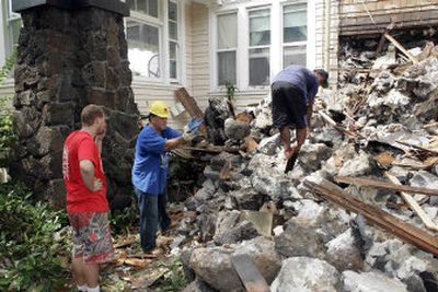 
Workers on Monday remove the rubble of a chimney that collapsed at Honolulu's Manoa Valley Inn during an earthquake Sunday. The house, built in 1912, sustained a collapsed chimney and structural damage to the roof. 
 (The Spokesman-Review)