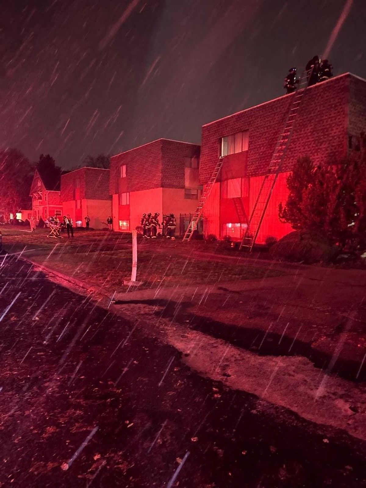 Spokane Fire Department crews placing ladders on apartment buildings for potential evacuations.   (Courtesy Spokane Fire Department)