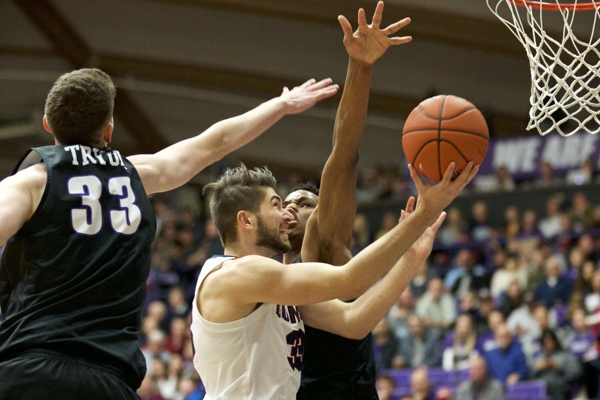 Gonzaga forward Killian Tillie, center, shoots past Portland center Theo Akwuba, right, and forward Jacob Tryon, left, during the first half of an NCAA college basketball game in Portland, Ore., Saturday, Jan. 19, 2019. (Craig Mitchelldyer / AP)