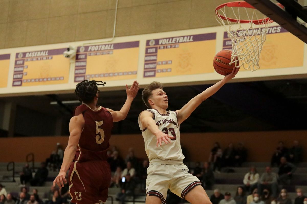 Mt. Spokane’s Xavier Kamalu-Vargas drives to the hoop against University in a District 8 3A loser-out at Rogers High Thursday. (CHERYL NICHOLS/For The Spokesman-Review)