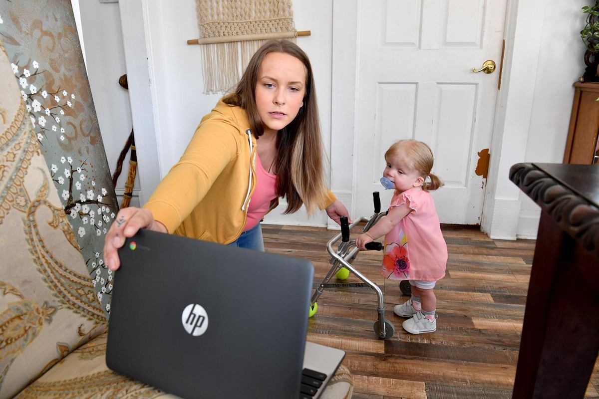 Jessica Burkhart and her 19-month-old daughter, Journey, work through a therapy video session with Joya physical therapist Ginette Kerkering and special education teacher Rebekah Edvalson on Wednesday, April 29, 2020, at Burkhart