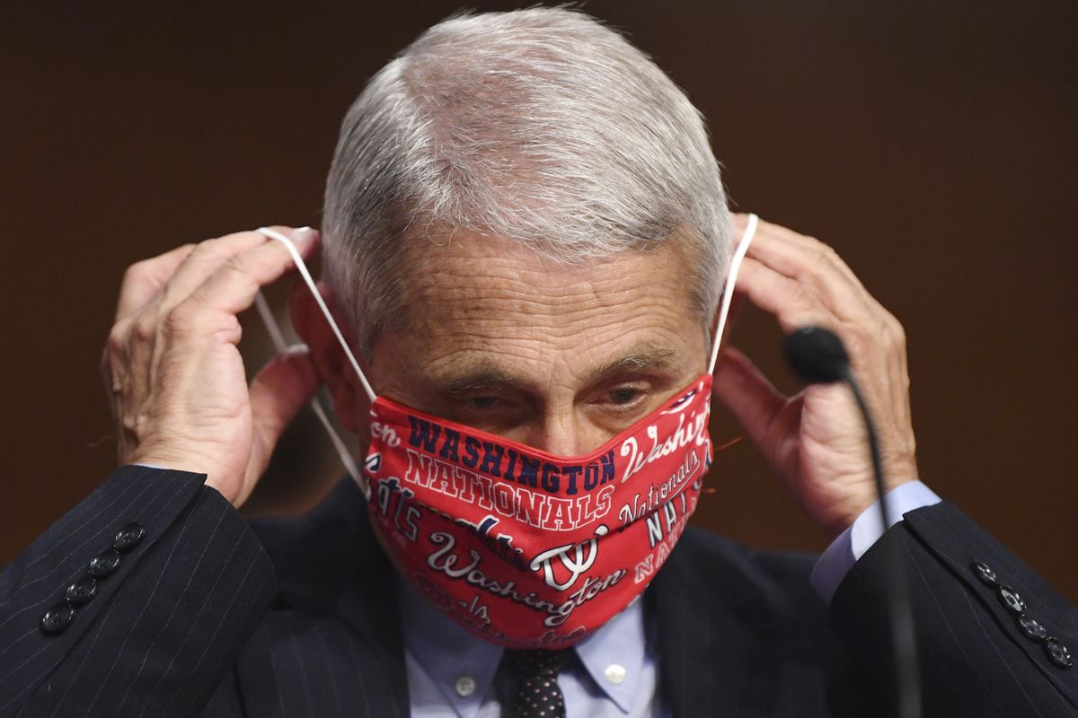 Dr. Anthony Fauci, director of the National Institute for Allergy and Infectious Diseases, lowers his face mask as he prepares to testify before a Senate Health, Education, Labor and Pensions Committee hearing on Capitol Hill in Washington, Tuesday, June 30, 2020.  (Kevin Dietsch)