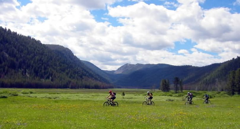Mountain bikers cross Warm Springs meadow on the Warm Springs Trail in the proposed Boulder-White Clouds wilderness area in central Idaho.  (Chris Cook / Associated Press)