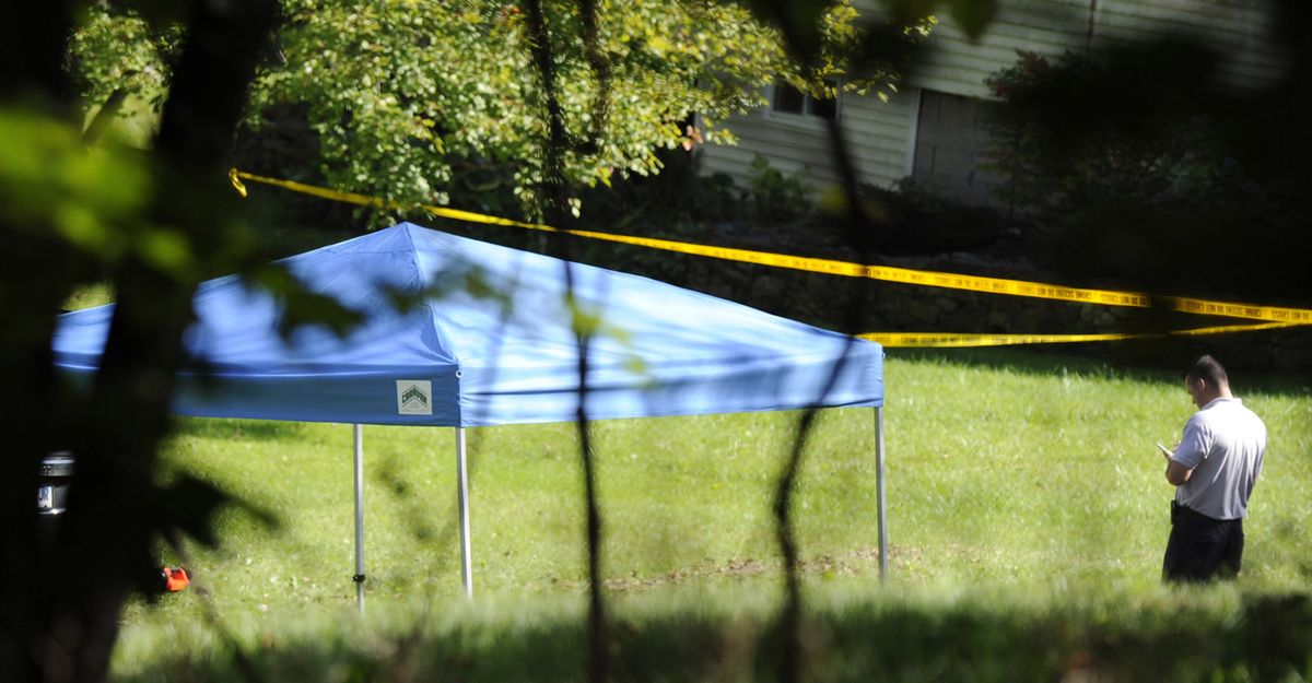A blue tent protects the scene of a fatal shooting on Meeting House Hill Circle in New Fairfield, Conn., Thursday, Sept, 27, 2012. A Connecticut man fatally shot a masked teenager in self-defense during what appeared to be an attempted burglary early Thursday morning, then discovered that he had killed his son, state police said. (Carol Kaliff / The News-times)