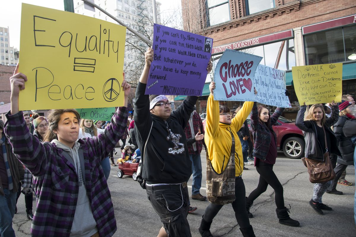 Marchers carry signs supporting the civil rights message and life work of Martin Luther King Jr. during the Unity Rally on Monday in downtown Spokane. (Colin Mulvany)