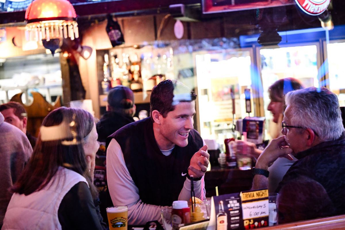 Kirby Moore, WSU’s new football coach smiles as he visits with Karen Teague, left, and Gary Teague during a meet and greet with alumni and fans on Thursday at the Swinging Doors in Spokane. The Teagues are both alumni and Gary played strong and free safety for WSU during his time in school. (Tyler Tjomsland/The Spokesman-Review)