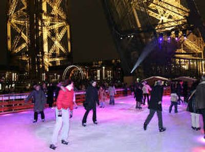 
Parisians skate on a rink set 188 feet above the ground on the Eiffel Tower in Paris. Lodged between two of the tower's immense latticed steel legs, visible in background, the rink is 2,150 square feet. It will remain open until Jan. 23. 
 (Associated Press / The Spokesman-Review)