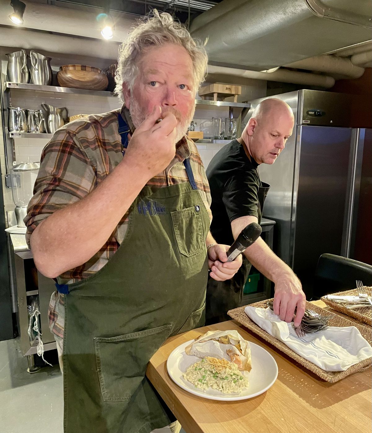 Seattle restaurateur Tom Douglas tries a creation by former food critics Nancy Leson and Leslie Kelly. (Leslie Kelly)