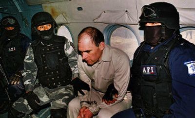 
 Alleged Gulf cartel leader Osiel Cardenas is moved during his extradition to the United States from Mexico on Friday. 
 (Associated Press / The Spokesman-Review)