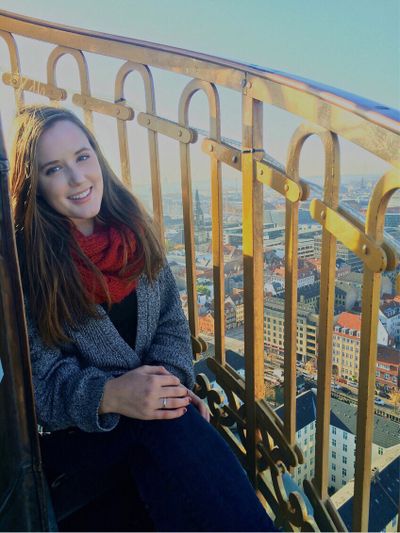 Kylie Mohr, at the top of a church spire, Vor Frelsers Kirke (Church of Our Saviour) overlooking central Copenhagen. Photo by Ina Deljkic