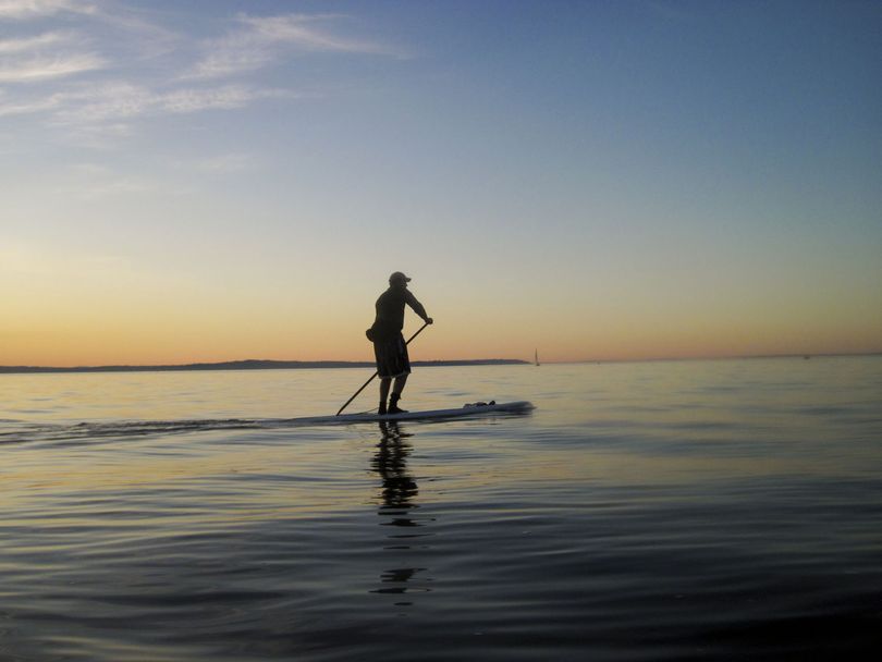 Rob Casey demonstrates stand up paddling on his board in Puget Sound. (Courtesy photo)